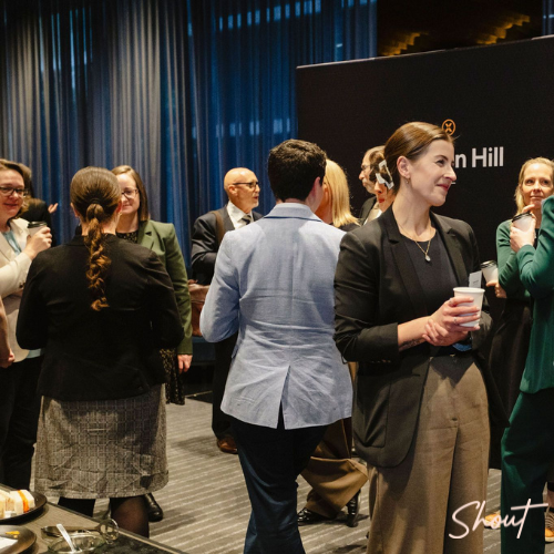 People socializing at a casual indoor gathering with drinks.