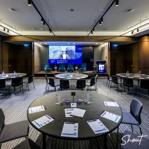 Conference room with round tables set for a meeting or seminar.