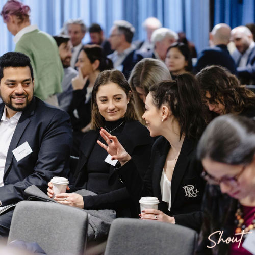 People engaged in lively conversation at a conference or seminar.