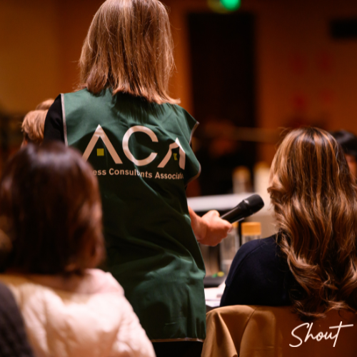Woman hosting a live event or workshop, engaging audience.