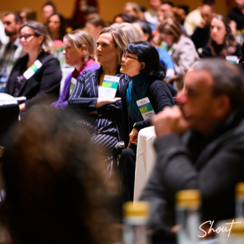 Audience attentively listening during a conference session.