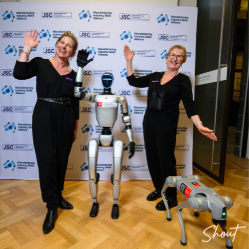 SHOUT Productions team members posing with robotics technology at the National Manufacturing Workforce Forum in Melbourne.