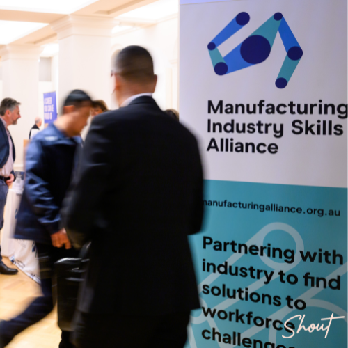 Delegates networking beside Manufacturing Industry Skills Alliance signage during the National Manufacturing Workforce Forum.